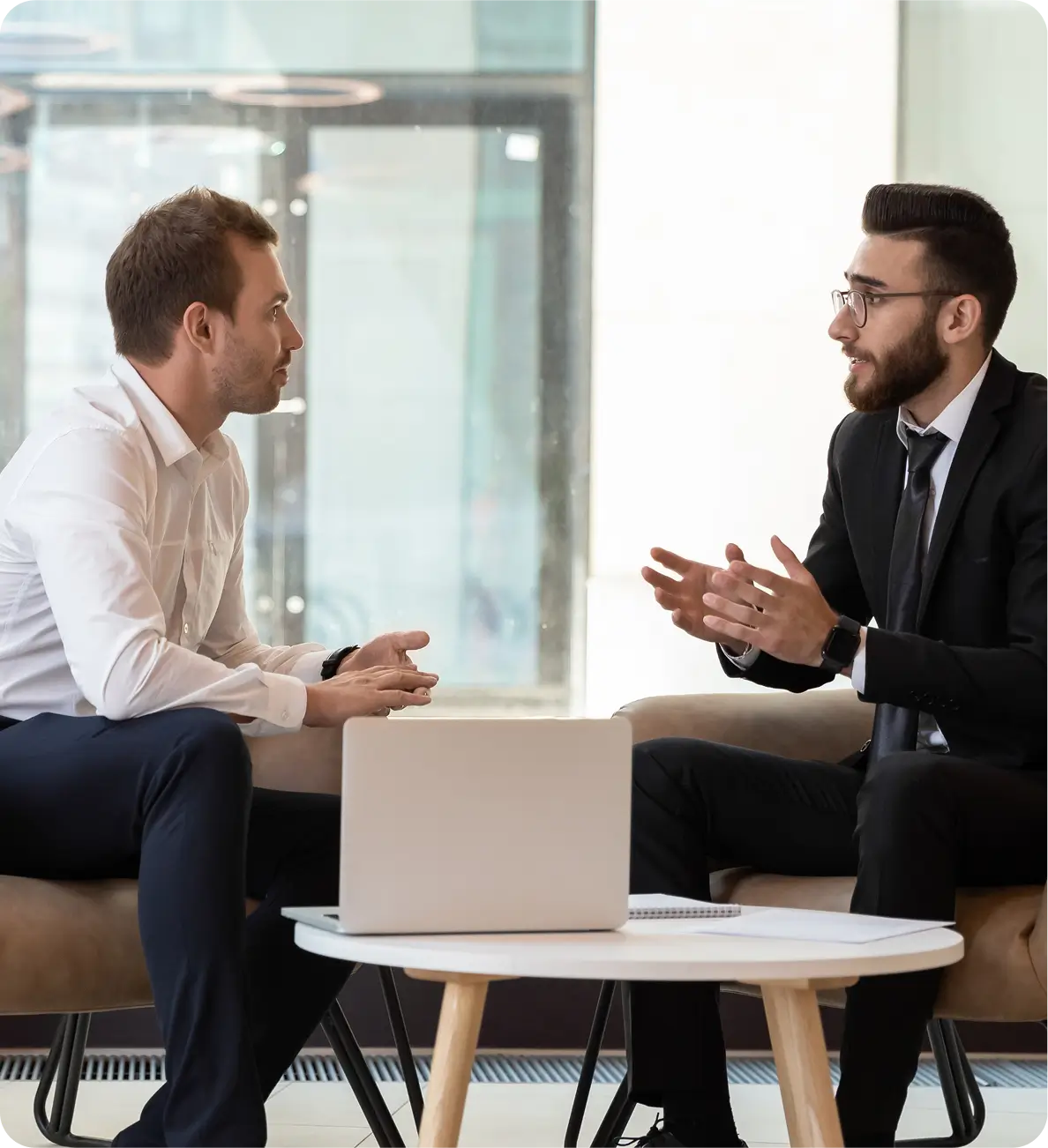 Two men discussing in a modern office.